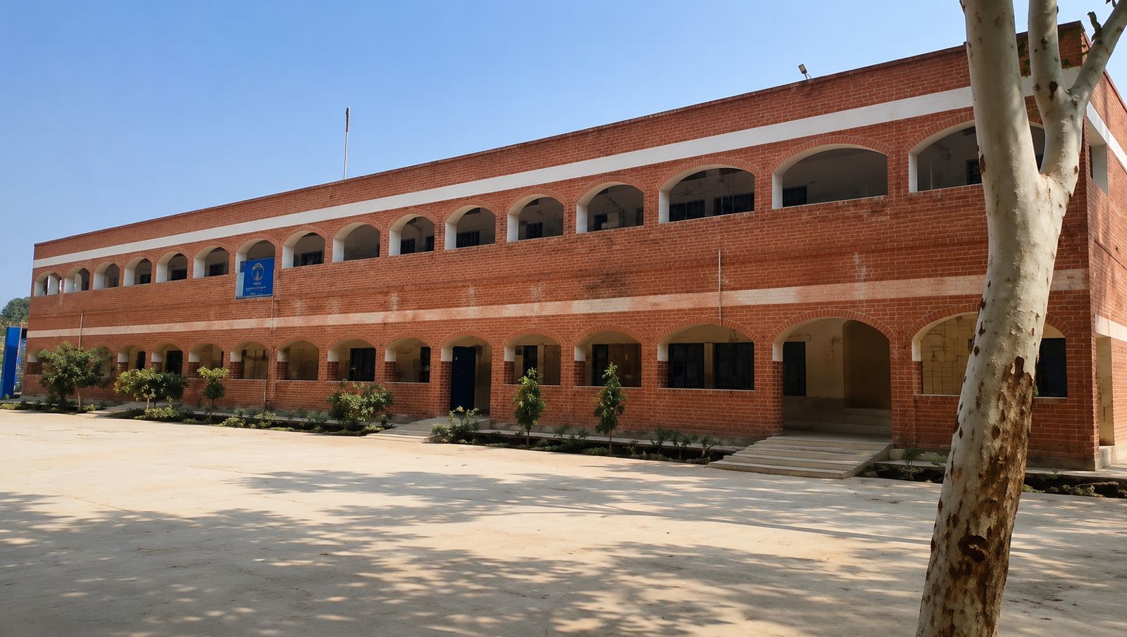 Two-storey government school building with exposed brick arches, constructed with BBC1 Zigzag kiln bricks in Haryana
